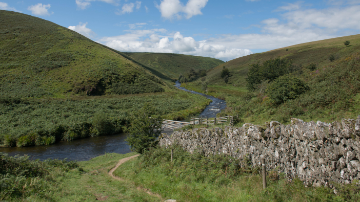 Rural,Moorland,Landscape,With,A,Flood,Defence,On,The,River