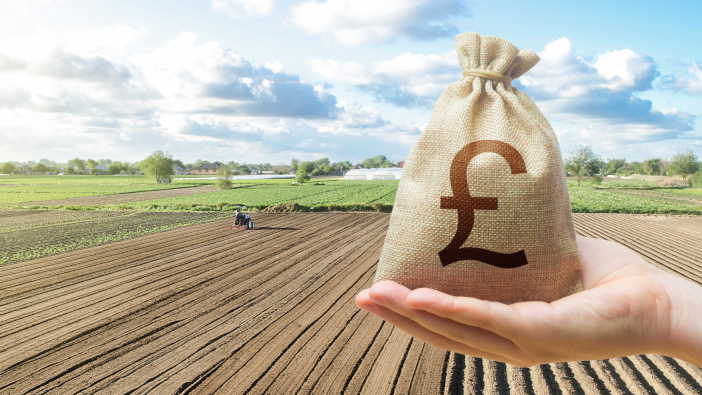 Rural Payments Agency looks back on 2021 Hand,With,British,Pound,Sterling,And,A,Farmer,On,A