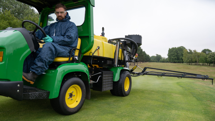 Steve Hardy spraying a green at TLGC with the John Deere HD200