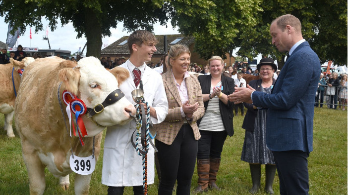 Young Handler trophy awarded to Simmental breeder by Prince William Young Handler