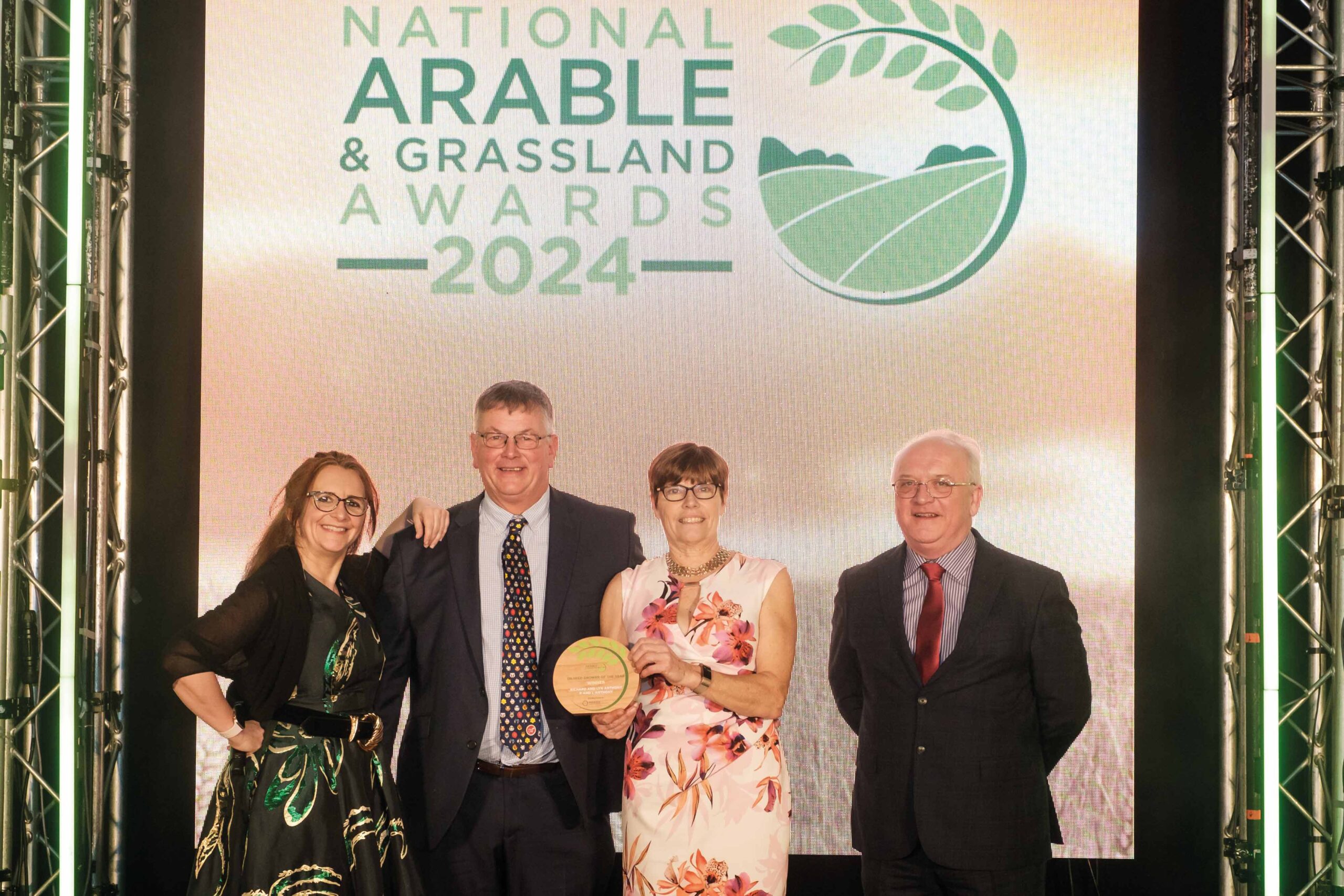 Richard and Lyn (centre) accept the Oilseed Grower of the Year award from host Lucy Porter and Premium Crops’ Nigel Padbury