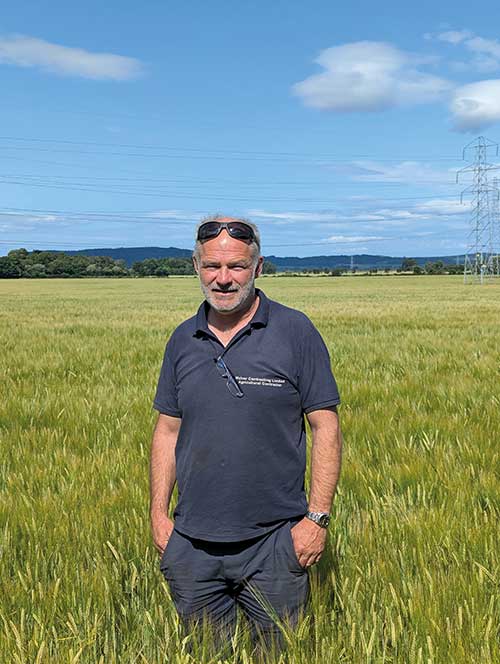 Neil McIver standing in field