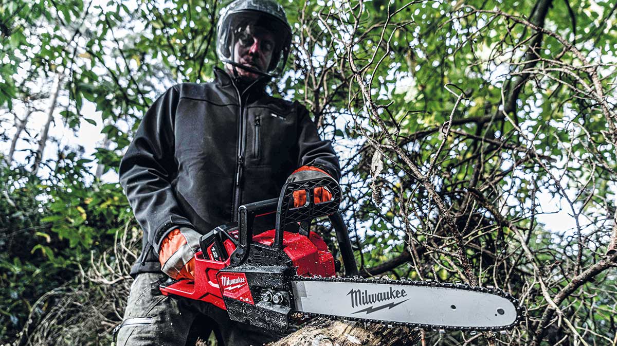 Man with rear-handled chainsaw