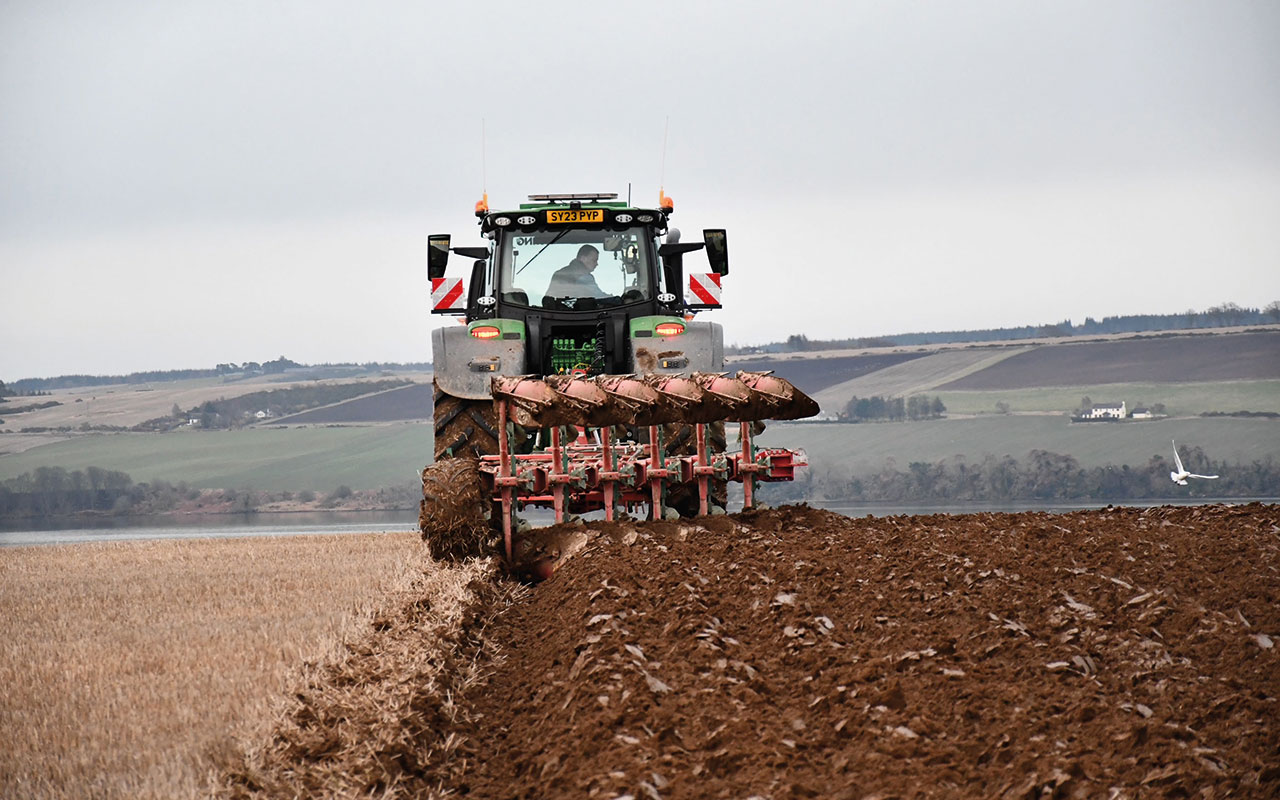 Plough working in field