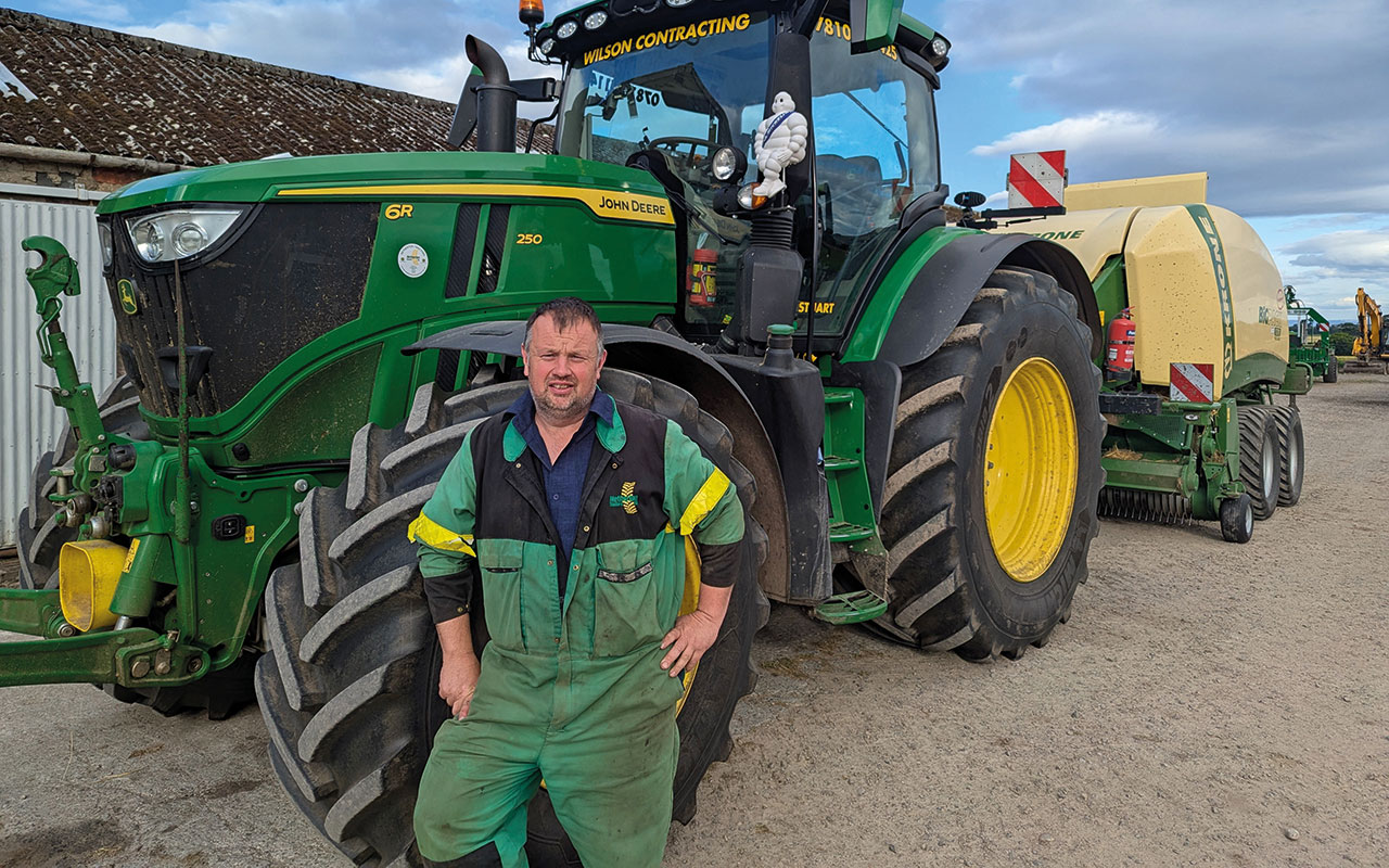 Stuart Wilson in front of tractor